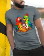 Colorful Parrot Family Nest Illustration Cute Cartoon Graphic Tee - model wearing grey tee, leaning on column
