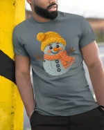 Cute Knitted Snowman Winter Art T Shirt With Cozy Joy - model wearing grey tee, leaning on column