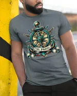 Vintage Pirate Ship Wheel Anchor Emblem Nautical Graphic T Shirt - model wearing grey tee, leaning on column