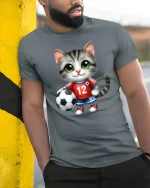 Cute Soccer Cat Cartoon Graphic Tee With Playful Sports Style - model wearing grey tee, leaning on column