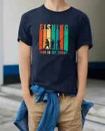 Fishing This Is My Hobby Vintage Style Angler Graphic Tee - model wearing navy tee with hands in pockets