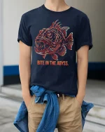 Bite In The Abyss Deep Sea Fish Graphic T Shirt Dark Ocean Art - model wearing navy tee with hands in pockets