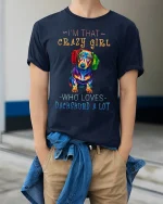Im That Crazy Girl Dachshund Graphic T Shirt Colorful Dog Art - model wearing navy tee with hands in pockets