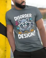 Disorder Is My Design Raccoon Graphic T Shirt Funny Quote Art - model wearing grey tee, leaning on column