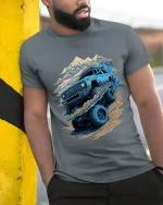 Off Road Mountain Adventure Truck Graphic Tee Shirt Design - model wearing grey tee, leaning on column