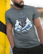 Nautical Anchor Graphic Tee With Ocean Waves And Timeless Sea Power - model wearing grey tee, leaning on column