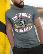 The Terror In The Arena Monster Graphic T Shirt Fierce Battle Tee - model wearing grey tee, leaning on column