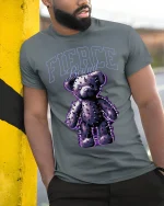 Fierce Bound Spiked Teddy Bear Graphic Tee With Dark Edge - model wearing grey tee, leaning on column