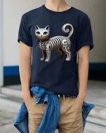 Cute Skeleton Cat Cartoon Graphic T Shirt Design - model wearing navy tee with hands in pockets
