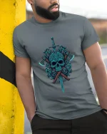 Dark Skull Sword and Axes Graphic T Shirt Art - model wearing grey tee, leaning on column