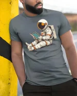 Reading Astronaut Space Graphic T-Shirt - model wearing grey tee, leaning on column