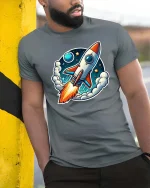 Retro Rocket T-Shirt Space Rocket Launch Cartoon Tee Gift - model wearing grey tee, leaning on column
