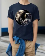 Astronaut Moon Space Graphic T-Shirt Cosmic Explorer Tee - model wearing navy tee with hands in pockets