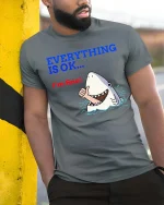 Funny Shark Everything Is OK Graphic T-Shirt Humor Ocean Tee - model wearing grey tee, leaning on column