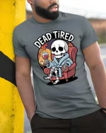 Dead Tired Funny Skeleton Relaxing Graphic T-Shirt - model wearing grey tee, leaning on column