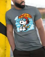 Cute Parachuting Dog Cartoon Graphic T-Shirt Skydiving Tee - model wearing grey tee, leaning on column