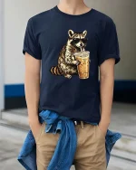 Cool Raccoon Iced Coffee T-Shirt Funny Animal Drink Tee - model wearing navy tee with hands in pockets