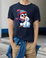 Cute Penguin Snowman T-Shirt Winter Holiday Cartoon Tee - model wearing navy tee with hands in pockets