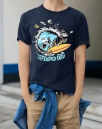 Stoopid Dog Surfing Shark Funny Surf Graphic T-Shirt - model wearing navy tee with hands in pockets