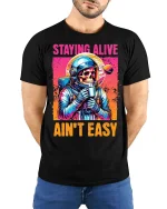 Staying Alive Ain’t Easy Funny Astronaut Skull T-Shirt - model wearing black tee with hands behind back