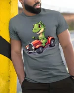 Funny Dinosaur Driving Car Cute Cartoon Dino Graphic T-Shirt - model wearing grey tee, leaning on column