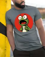 Funny Shocked Frog Cartoon Reaction Meme Graphic T-Shirt - model wearing grey tee, leaning on column