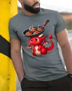Cute Dragon Cooking Steak Funny BBQ Cartoon T-Shirt Tee - model wearing grey tee, leaning on column