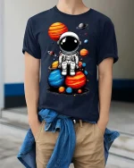 Cute Astronaut Sitting on Planets T-Shirt Space Graphic Tee - model wearing navy tee with hands in pockets