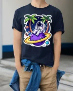 Astronaut Beach T-Shirt Space Vacation Galaxy Graphic Tee - model wearing navy tee with hands in pockets