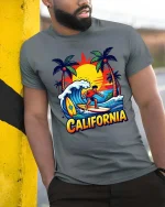 California Surfing T-Shirt Sunset Beach Surfer Graphic Tee - model wearing grey tee, leaning on column