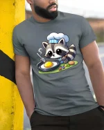 Cute Raccoon Chef Cooking T-Shirt Funny Animal Food Tee - model wearing grey tee, leaning on column