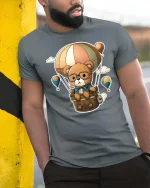 Cute Bear Balloon Adventure T-Shirt Cartoon Travel Tee - model wearing grey tee, leaning on column