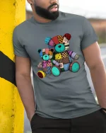 Colorful Patchwork Teddy Bear T Shirt Cute Vintage Toy Tee - model wearing grey tee, leaning on column