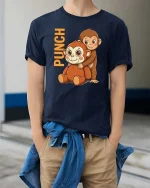 Funny Punch Monkey Cartoon Graphic T-Shirt Cute Humor Tee - model wearing navy tee with hands in pockets