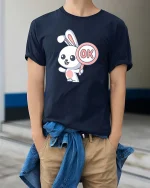 Cute Bunny OK Sign Cartoon Graphic T-Shirt Funny Kawaii Tee - model wearing navy tee with hands in pockets