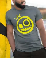 Graffiti Smile Crown Graphic T-Shirt Street Art Style - model wearing grey tee, leaning on column