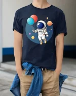 Astronaut Balloon T-Shirt Cute Space Explorer Graphic - model wearing navy tee with hands in pockets