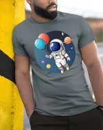 Astronaut Balloon T-Shirt Cute Space Explorer Graphic - model wearing grey tee, leaning on column
