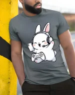 Cute Gamer Bunny T-Shirt Funny Cartoon Gaming Graphic Tee - model wearing grey tee, leaning on column