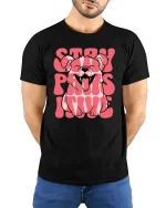 Stay Pawsitive Dog Graphic T-Shirt Cute Funny Puppy Tee - model wearing black tee with hands behind back