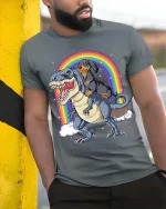 Dachshund Riding Dinosaur Rainbow Graphic T-Shirt Funny Tee - model wearing grey tee, leaning on column