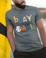Play Ball Baseball Graphic T-Shirt Funny Sports Fan Tee - model wearing grey tee, leaning on column