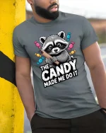 The Candy Made Me Do It Raccoon Funny Graphic T-Shirt - model wearing grey tee, leaning on column