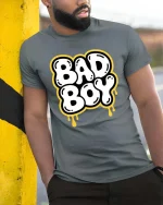 Bad Boy Graphic T-Shirt Bold Streetwear Drip Style Tee - model wearing grey tee, leaning on column