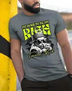 Born To Be Rich Baby Graphic T-Shirt Funny Money Street Tee - model wearing grey tee, leaning on column