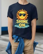 Shine On Sun T-Shirt Positive Summer Graphic Tee Fun - model wearing navy tee with hands in pockets
