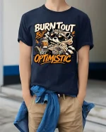 Burnt Out But Optimistic Raccoon T-Shirt Funny Graphic - model wearing navy tee with hands in pockets