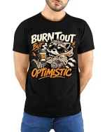 Burnt Out But Optimistic Raccoon T-Shirt Funny Graphic - model wearing black tee with hands behind back