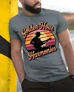 Golden Hour Guitar T-Shirt Vintage Sunset Music Graphic - model wearing grey tee, leaning on column