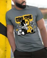 Stay True Teddy Bear T-Shirt Money Streetwear Graphic - model wearing grey tee, leaning on column